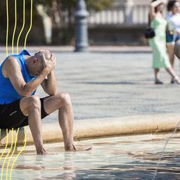 Ein Mann kühlt sich im zentralen Brunnen auf der Plaza de España in Sevilla ab.