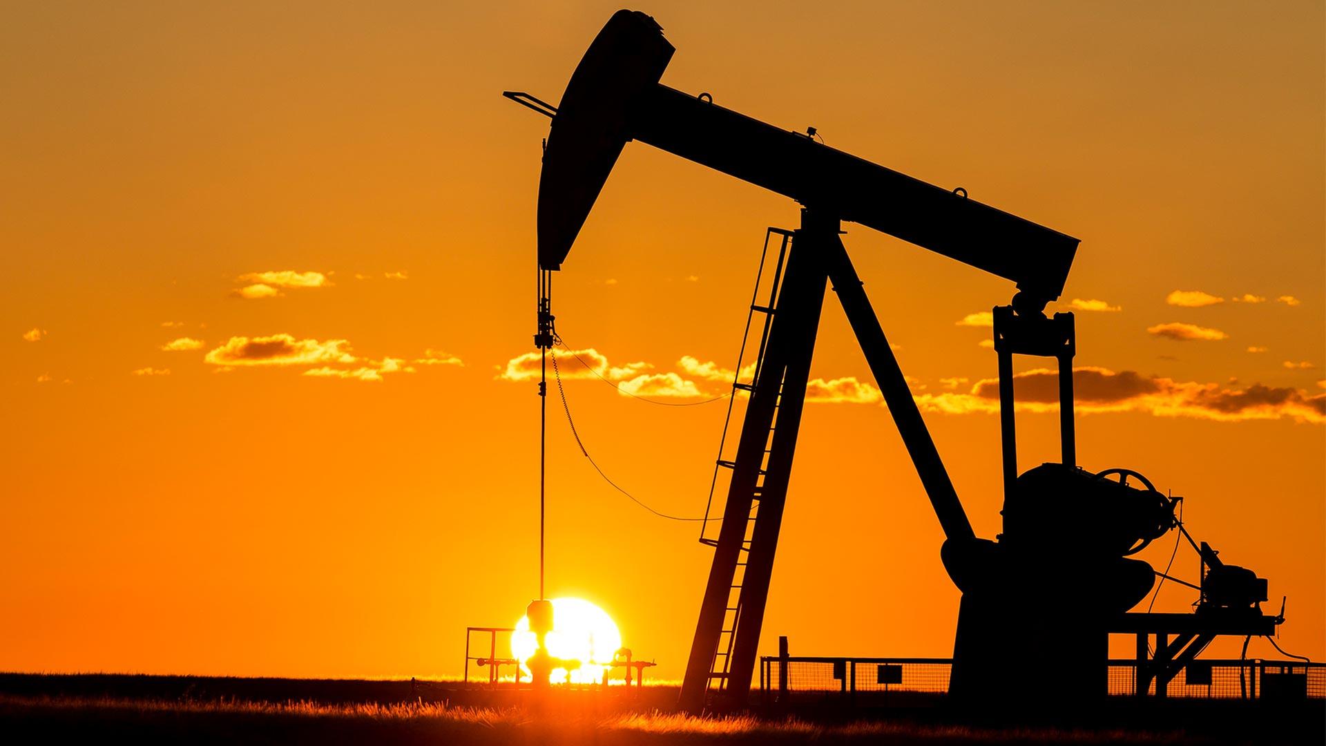 Silhouette einer Ölpumpe auf einem Ölfeld. | picture alliance / Design Pics