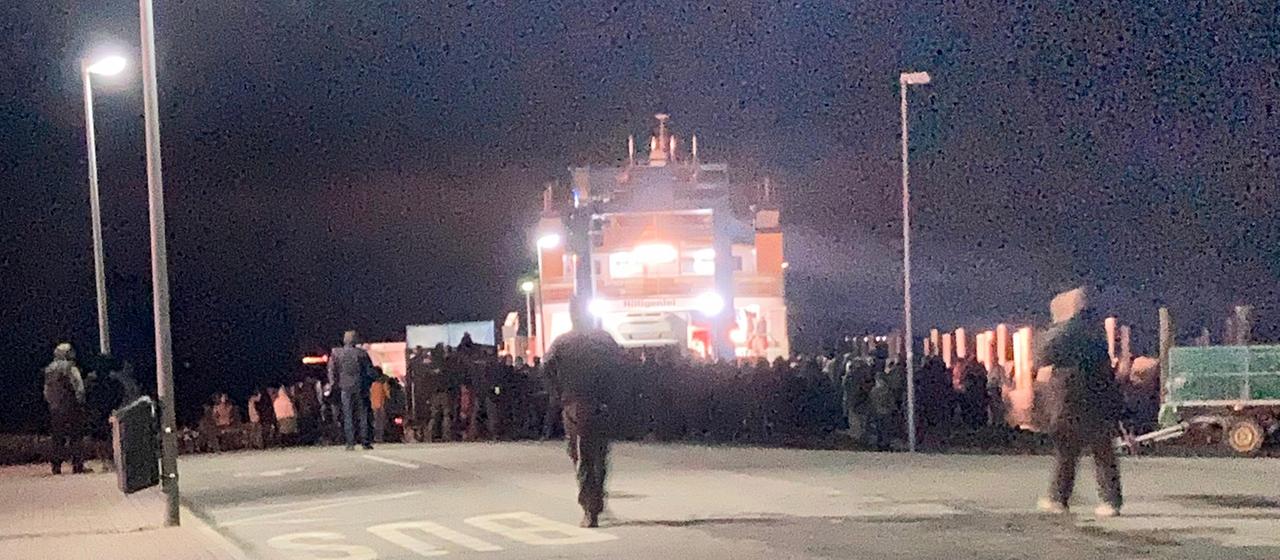 Bauern stehen in Schüttsiel vor einer Fähre.