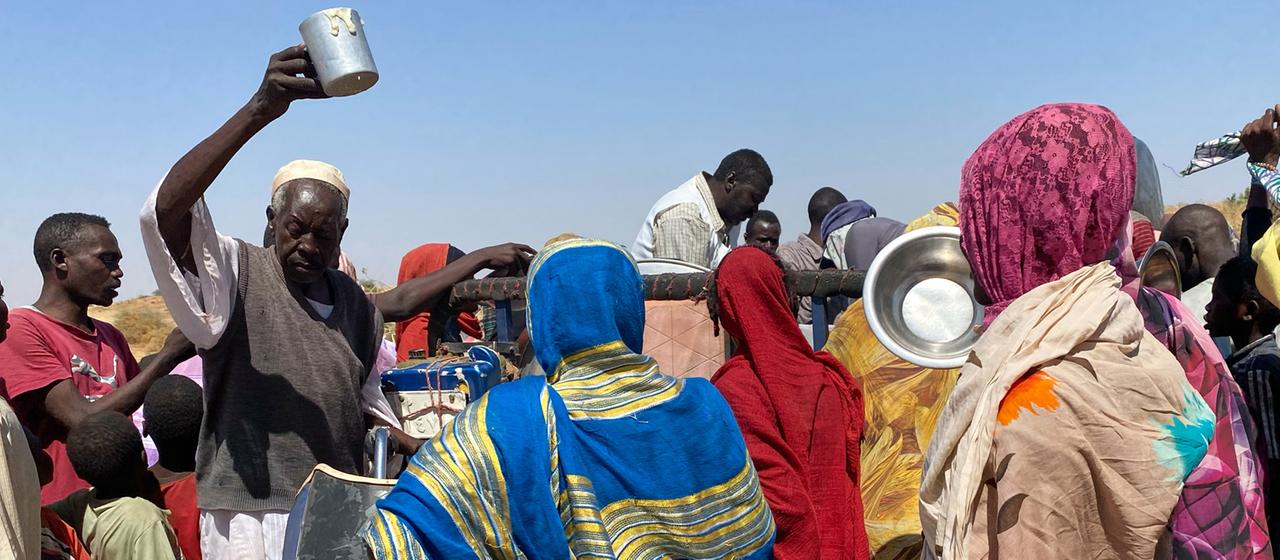 Menschen stehen in einem Flüchtlingslager in Tawila (Sudan) für Nahrungsmittel an.