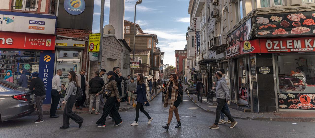 People walk down the street in the Fatih district of Istanbul. 