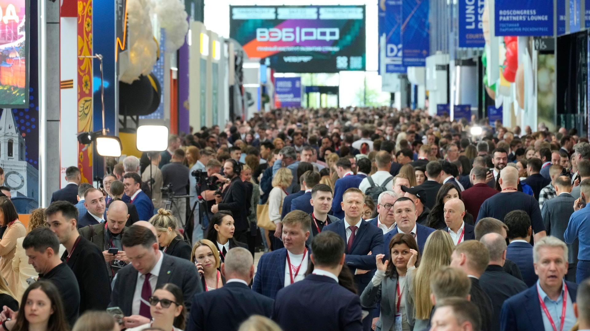 Besucher gehen durch die Hallen des Internationalen Wirtschaftsforums in St. Petersburg (SPIEF). | dpa