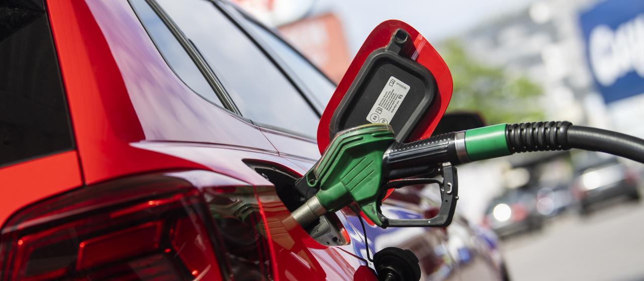 Eine Zapfpistole steckt in einem Tank.