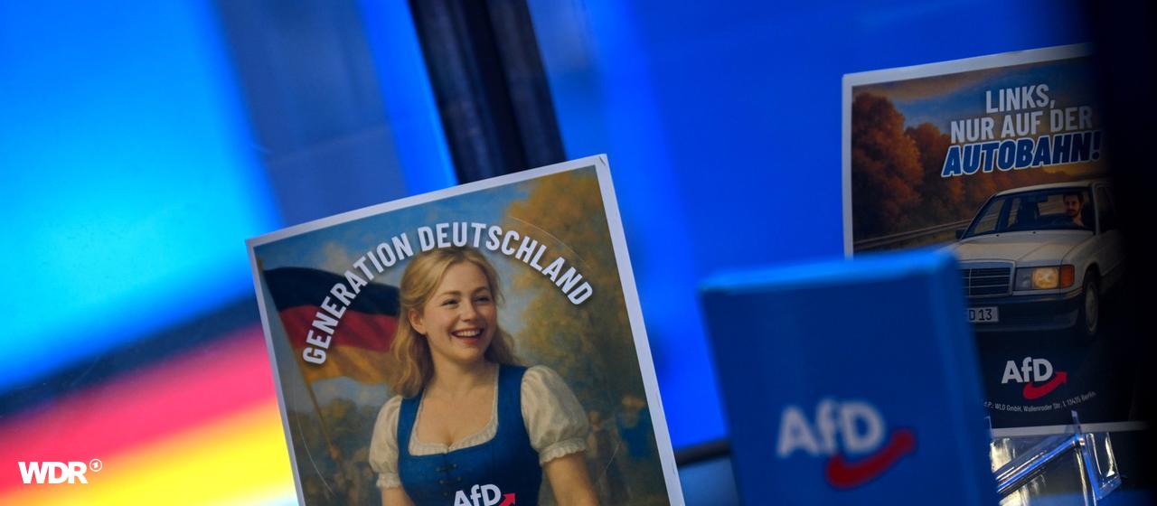 Sticker stehen auf einem Glastisch mit dem Slogan Generation deutschland. Auf dem einen ist eine blonde Frau in einem Dirndl zu sehen. Alle hhaben das AfD Logo drauf.