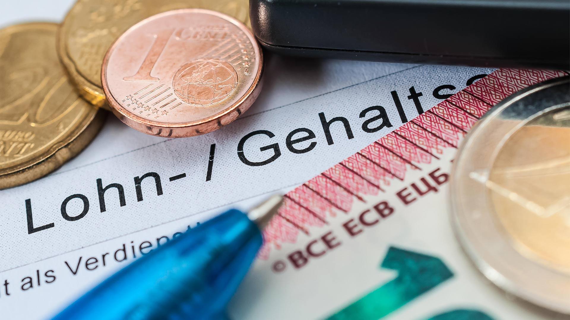 Lohn- und Gehaltsabrechnung, Bargeld, Stift und Taschenrechner. | picture alliance / Zoonar