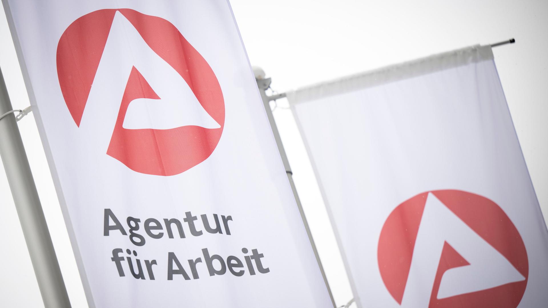 Fahnen mit dem Logo der Agentur fÃ¼r Arbeit wehen im Wind. | Philip Dulian/dpa