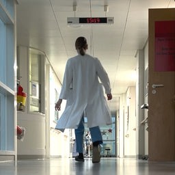 Eine Ärztin läuft im Flur der Uniklinik Regensburg entlang.