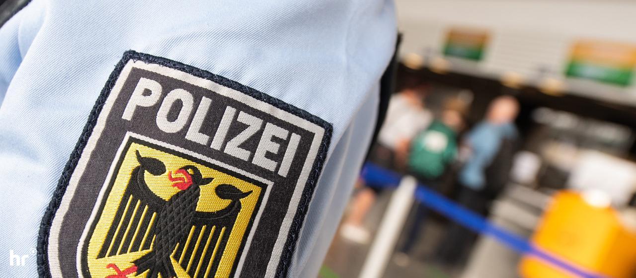 Wappen der Bundespolizei auf Hemd, im Hintergrund Flughafenkulisse