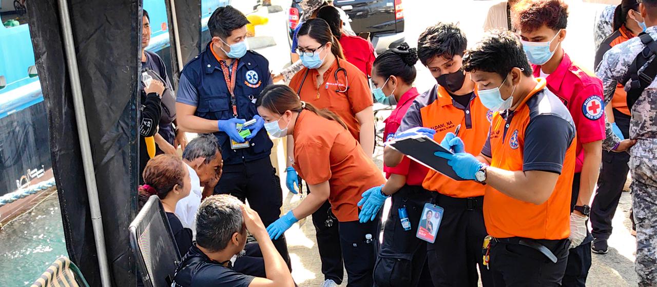 Rettungskräfte versorgen Überlebende der gesunkenen Fähre M/V Trisha Kerstin 3.