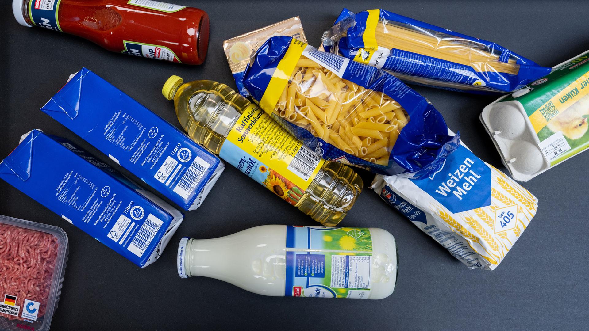 Lebensmittel liegen in einem Supermarkt in Leipzig an der Kasse auf dem Band.  | picture alliance/dpa