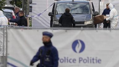 Forensische Beamte der belgischen Polizei arbeiten hinter einem abgesperrten Bereich.