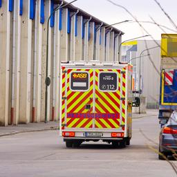 Ein Fahrzeug des Rettungsdienstes auf einer Straße am Rande eines Firmengeländes
