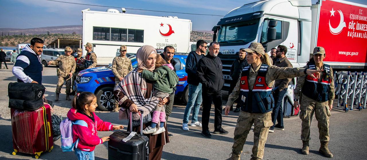 Menschen mit Gepäck an der türkischen Landesgrenze