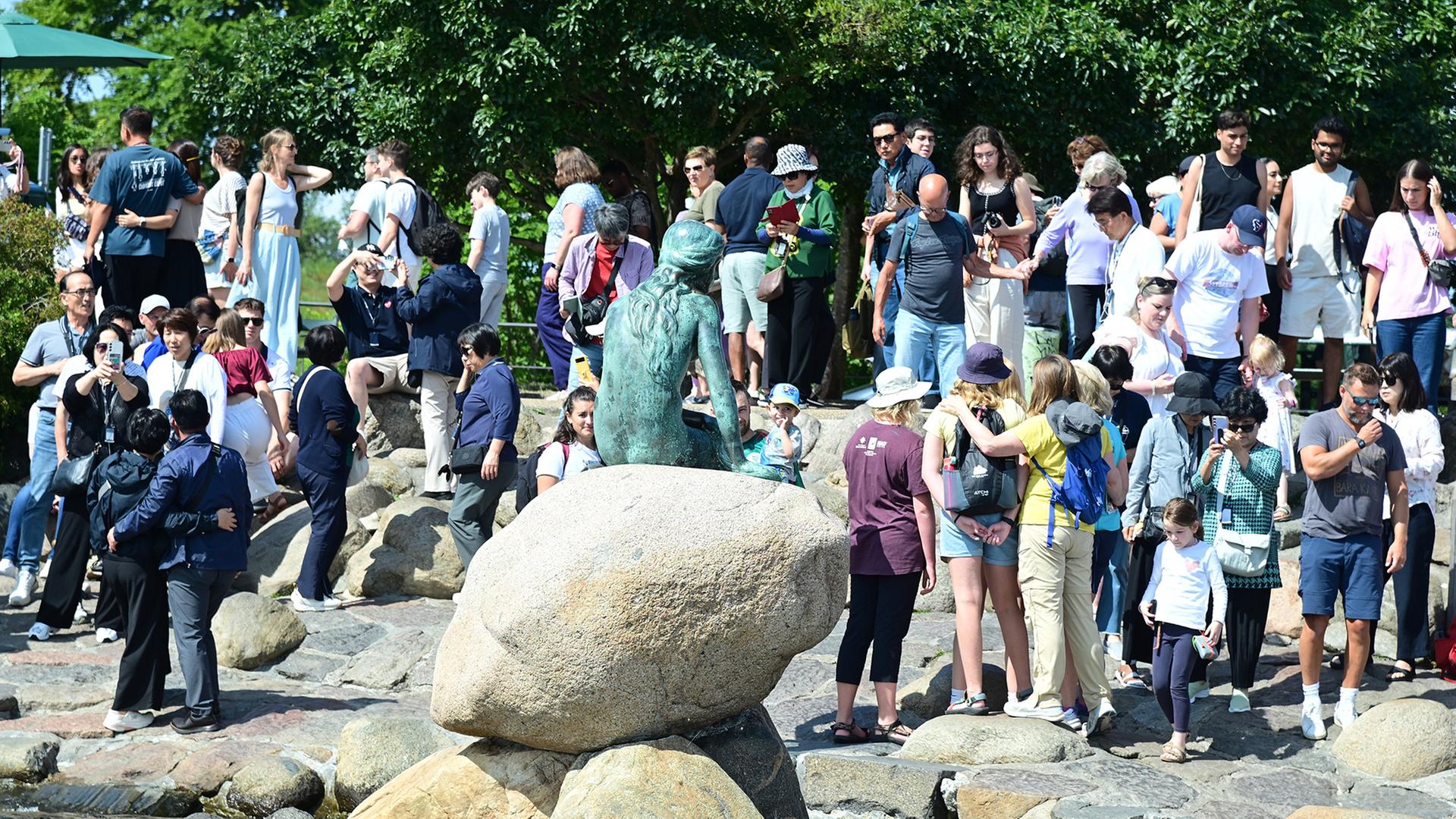 Zahlreiche Touristen stehen um die Statue der Meerjungfrau in Kopenhagen. | picture alliance / BeckerBredel