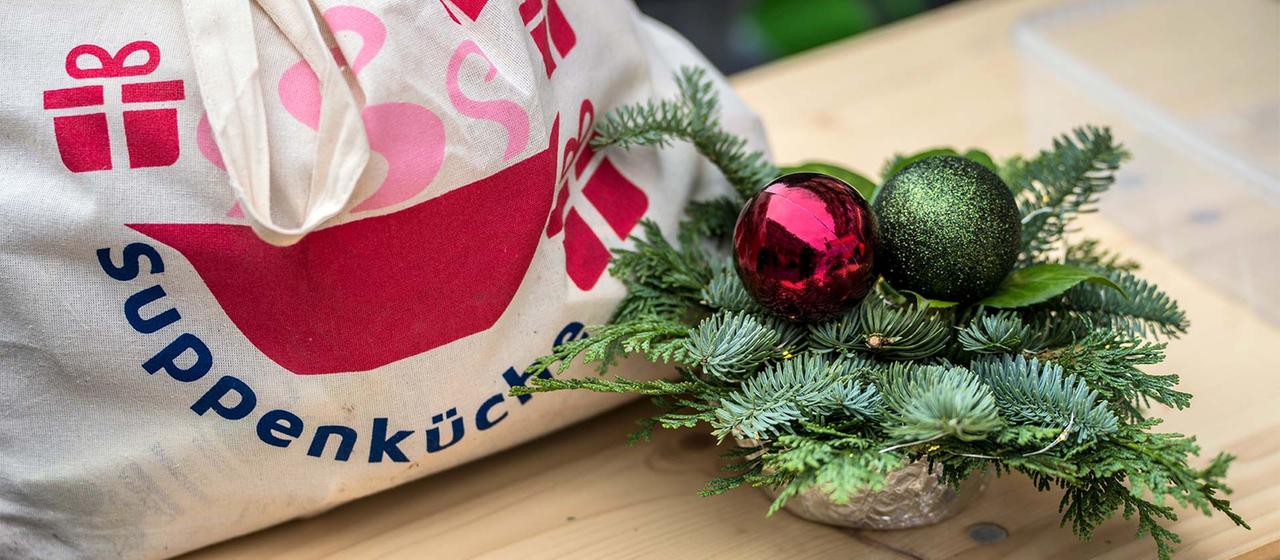 Einer von 350 Geschenkbeutel an Bedürftige und ein Weihnachtsgesteck.