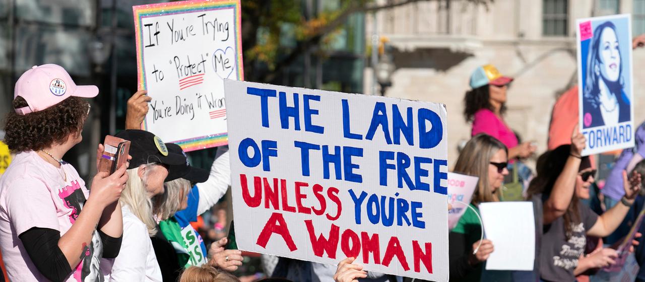 Demonstrantinnen halten Plakate beim Women's March.