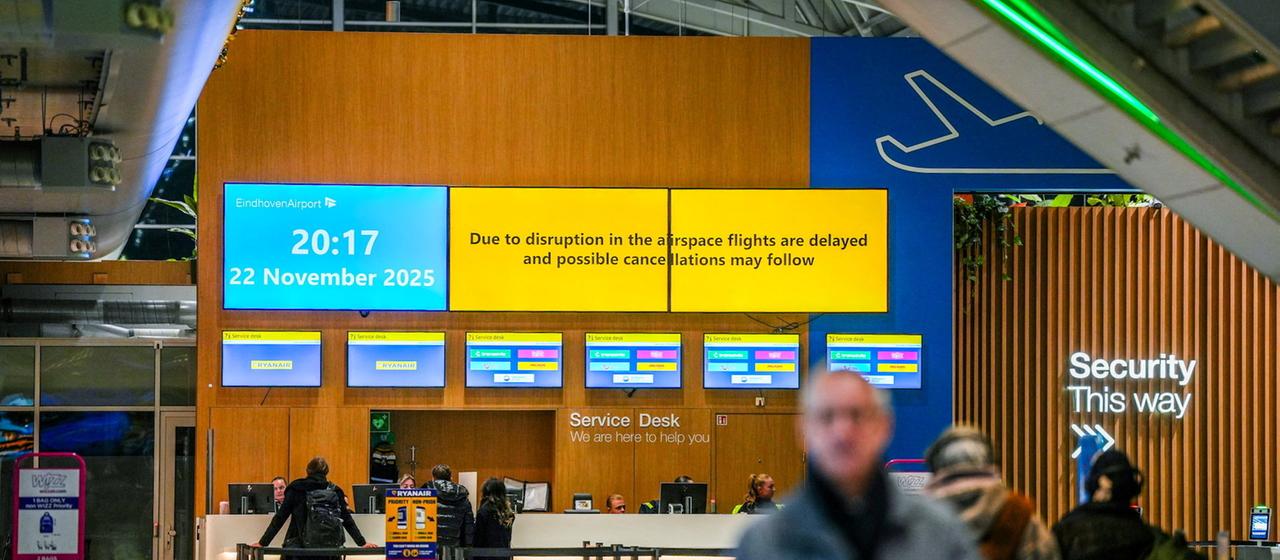 Screens at Eindhoven Airport provide information about a disruption to operations.