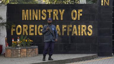 Ein bewaffneter Mann steht vor dem Eingang des Außenministeriums in Pakistan.