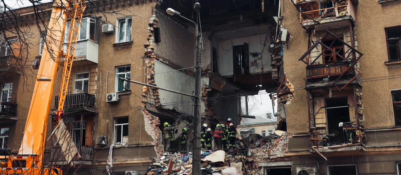 Ukrainian rescue workers work on a destroyed residential building in Odessa, Ukraine.