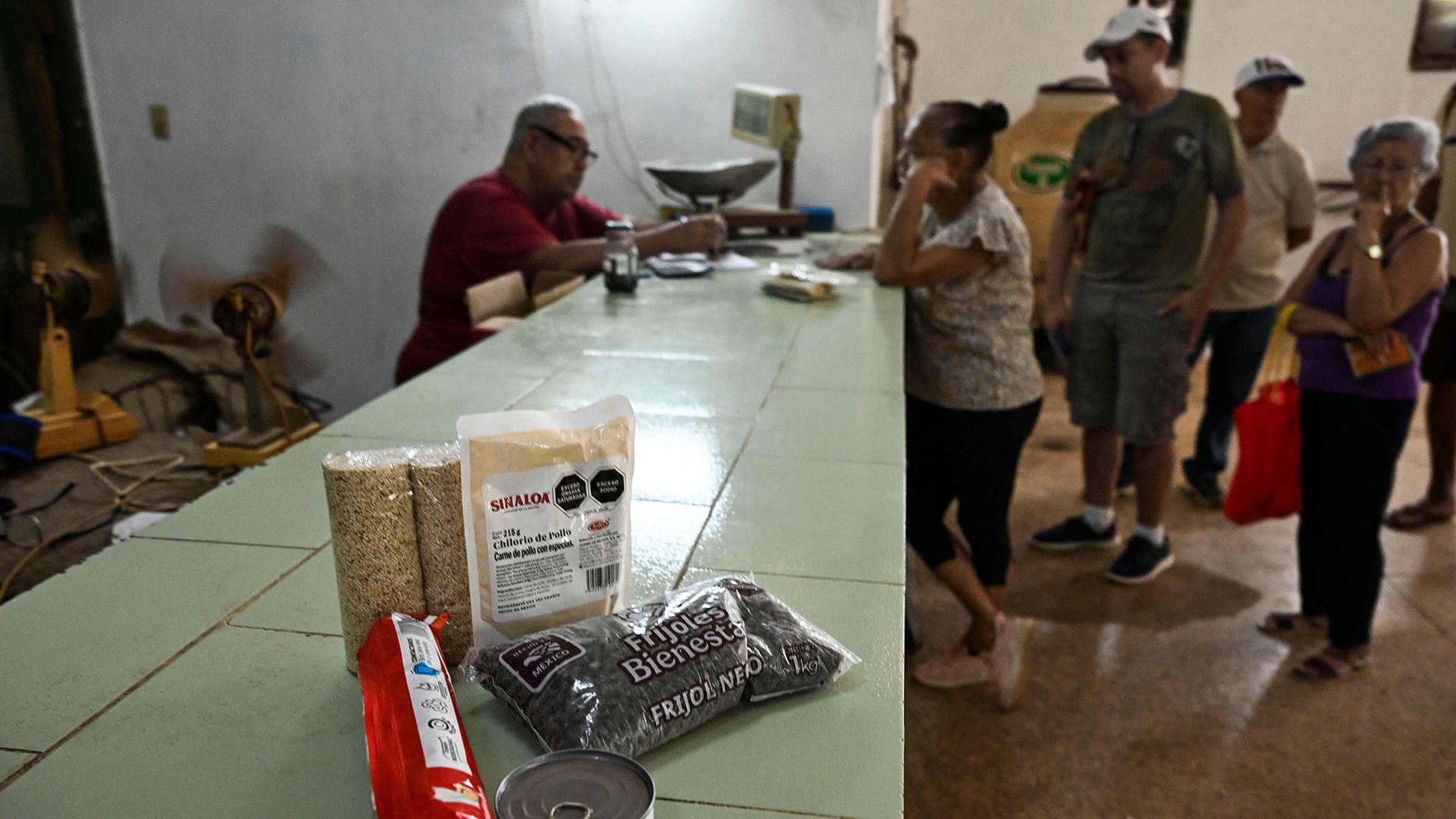 Menschen stehen in Havanna vor einem LebensmittelgeschÃ¤ft Schlange. | AFP