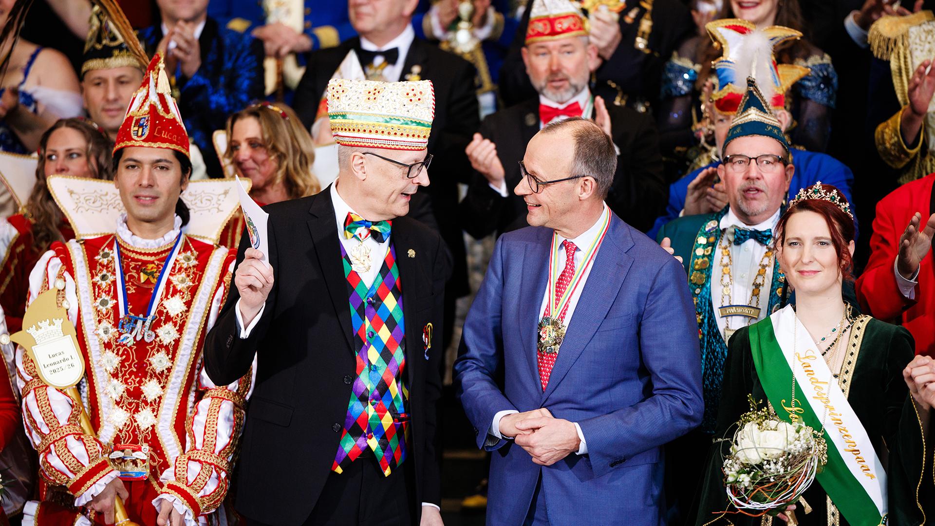 Friedrich Merz und Klaus Ludwig Fess posieren vor Karnevalisten . | EPA