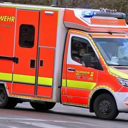 Ein Krankenwagen fährt mit Blaulicht durch eine Straße zu einem Einsatz