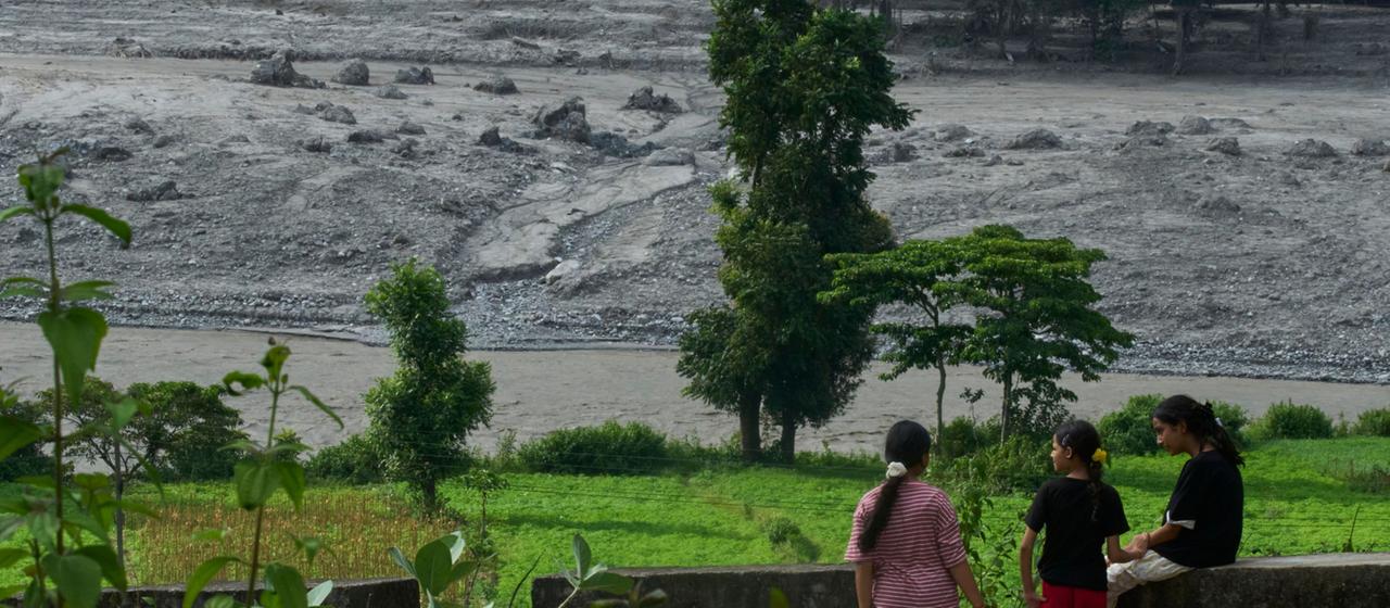 Überlebende der Flutkatastrophe schauen auf den Fluss Trishuli in Nepal.