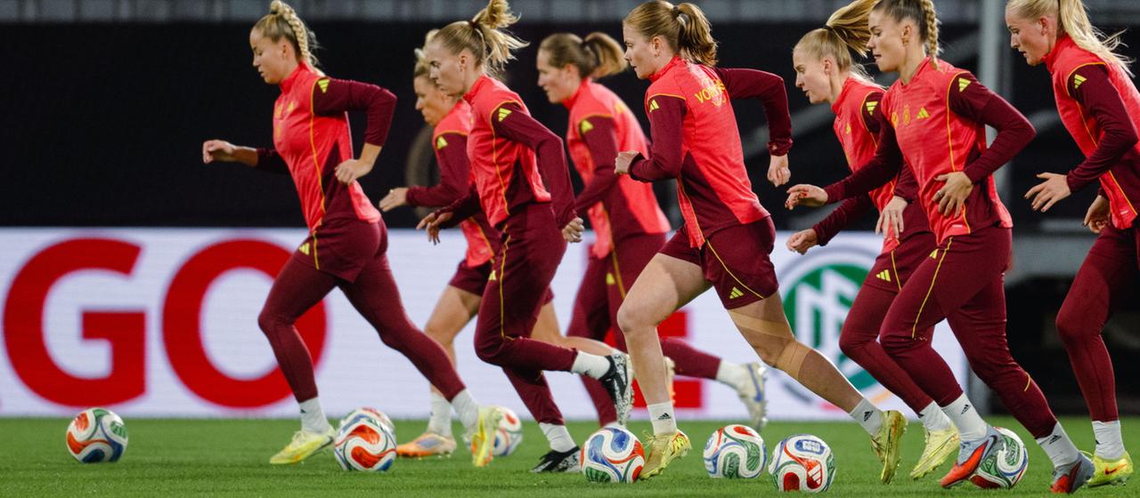 Die Spielerinnen laufen mit dem Ball.