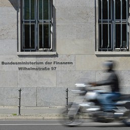 Ein Motorrad fährt am Bundesministerium der Finanzen vorbei.