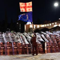 Ein Demonstrant schwenkt in der Innenstadt von Tiflis vor der Bereitschaftspolizei eine georgische und eine EU-Flagge. (Archivbild: 4.10.2025)