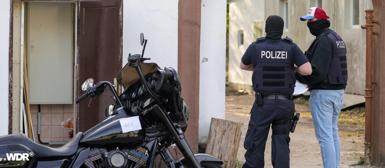 A motorcycle that was confiscated by police as part of a raid against the rocker group Hells Angels stands in front of a house