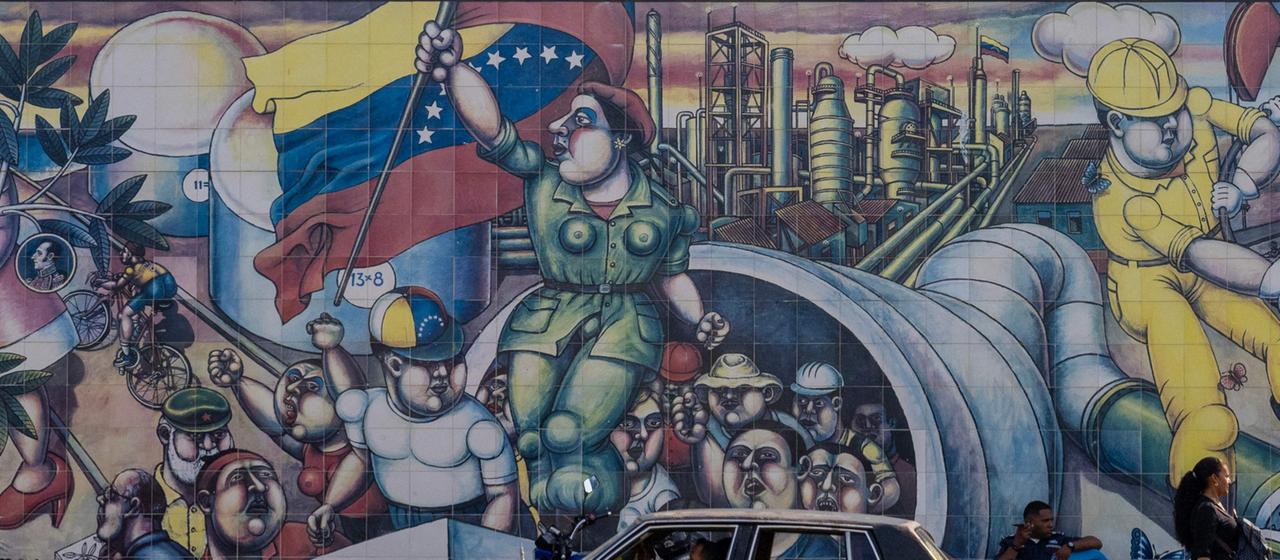 Ein Auto fährt in Maracaibo an einem Wandbild vorbei.