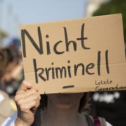 Schild mit der Aufschrift "Nicht kriminell" bei einer Demo der Klimaaktivisten.