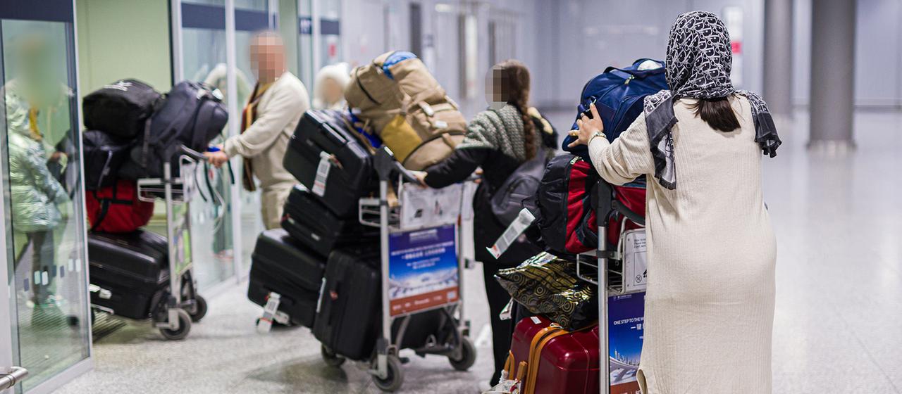 Menschen aus Afghanistan verlassen mit ihrem Gepäck das Flughafengebäude vom Flughafen Hannover-Langenhagen.