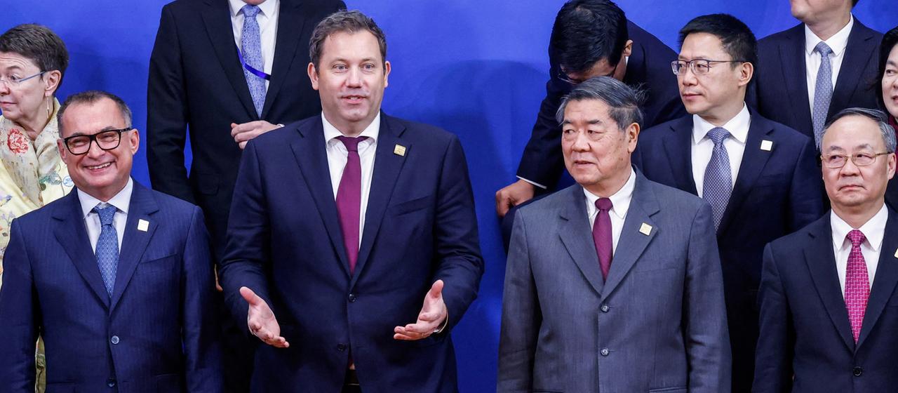 Finanzminister Lars Klingbeil und der chinesische Vizepremier He Lifeng inmitten einer Gruppe von deutschen und chinesischen Vertretern.