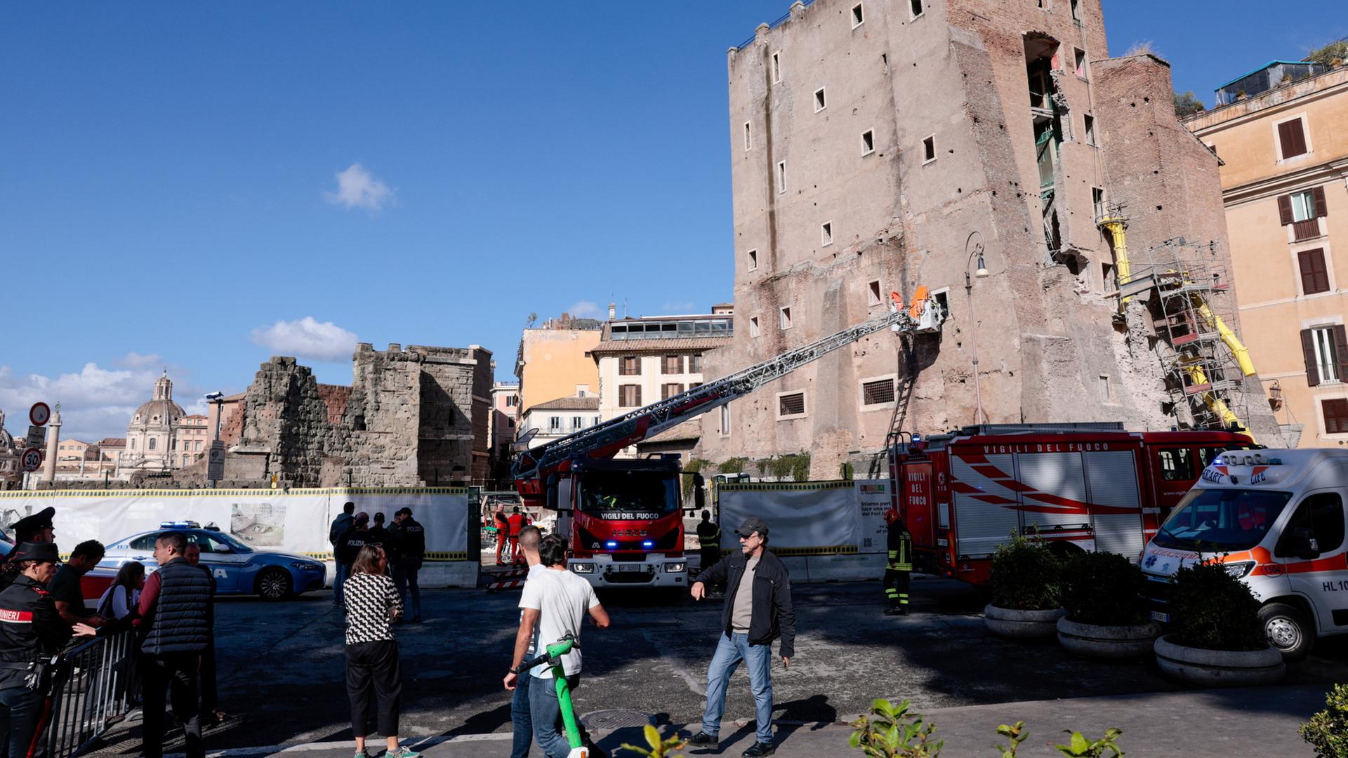 Passanten gehen am Torre dei Conti in Rom (Italien) nach dessen Teileinsturz vorbei. | REUTERS