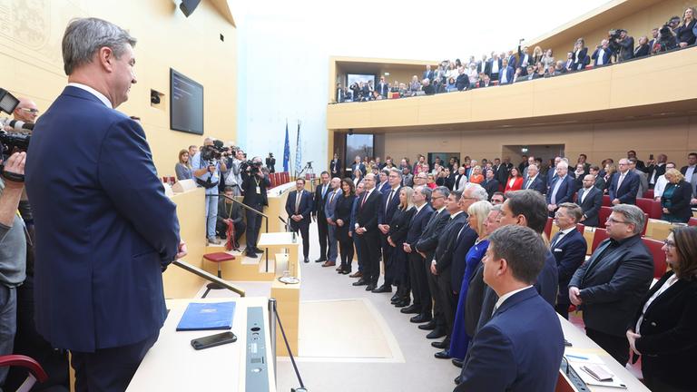 Mitglieder des bayerischen Kabinetts stehen während der Vereidigungszeremonie vor Ministerpräsident Markus Söder.