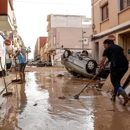 Anwohner säubern eine mit Schlamm bedeckte Straße in der vom Hochwasser betroffenen Gemeinde Paiporta in der Provinz Valencia.