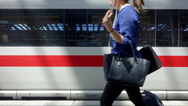 Frau vor ICE im Hauptbahnhof
